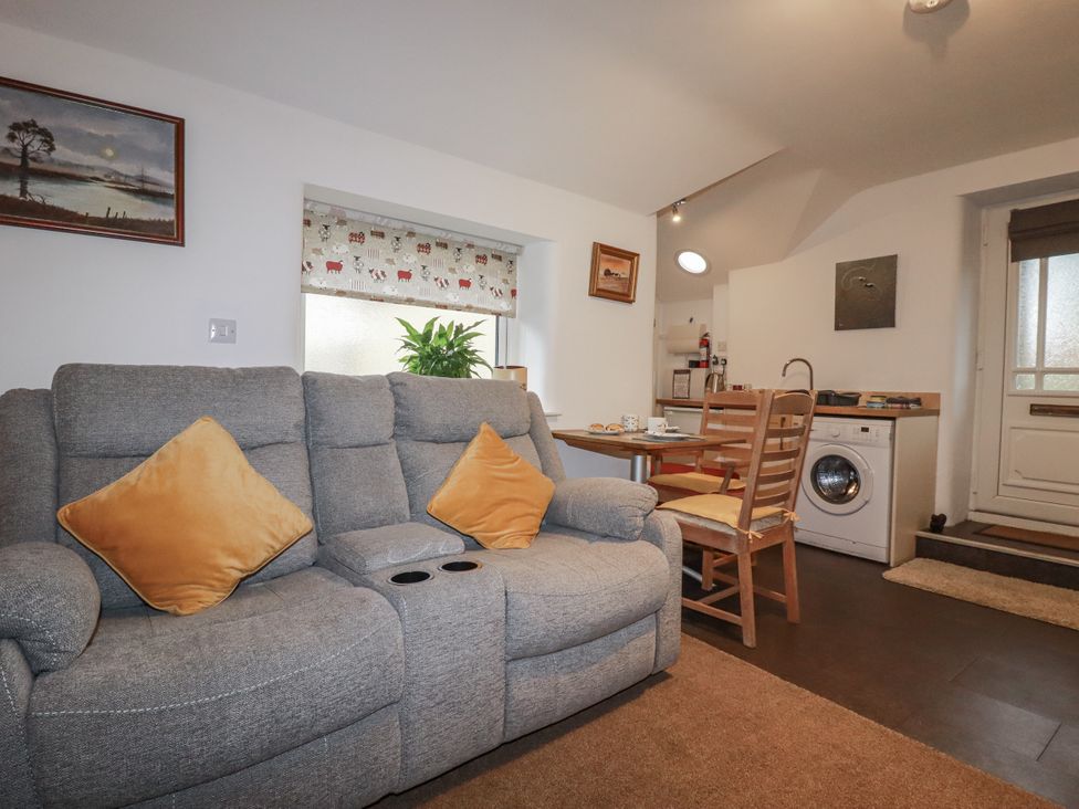 A living room with a sofa and table at Bramble Barn near Lanivet