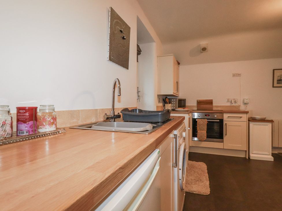 A kitchen with a sink and oven at Bramble Barn Inches near Lanivet