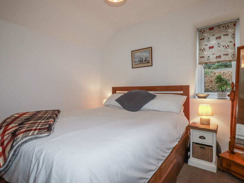 A bedroom with a bed and nightstand at Bramble Barn Inches near Lanivet