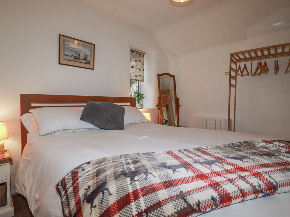 A bedroom with a bed and a mirror at Bramble Barn Inches near Lanivet