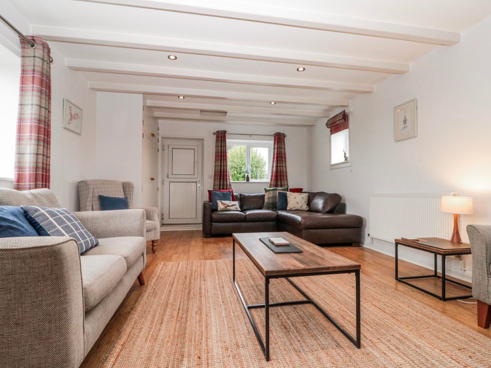 A living room with sofas and a coffee table at Wold Cottage in Hunmanby