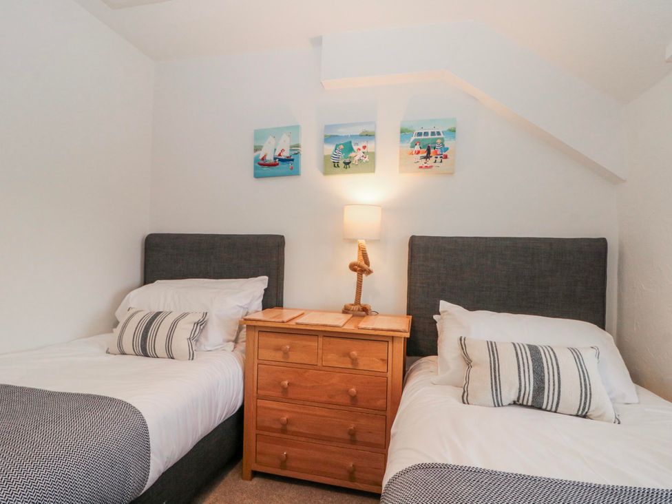A bedroom with two single beds and a nightstand at Wold Cottage in Hunmanby