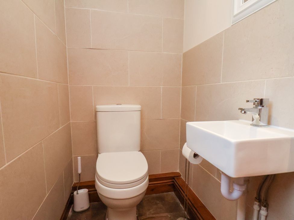A bathroom with a toilet and sink at The Farmhouse in Boggle Hole near Robin Hood's Bay