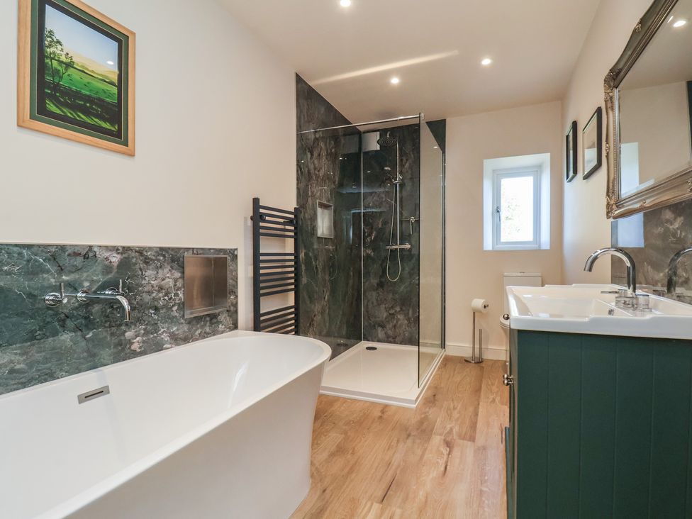 A bathroom with a shower and bathtub at The Farmhouse in Boggle Hole near Robin Hood's Bay