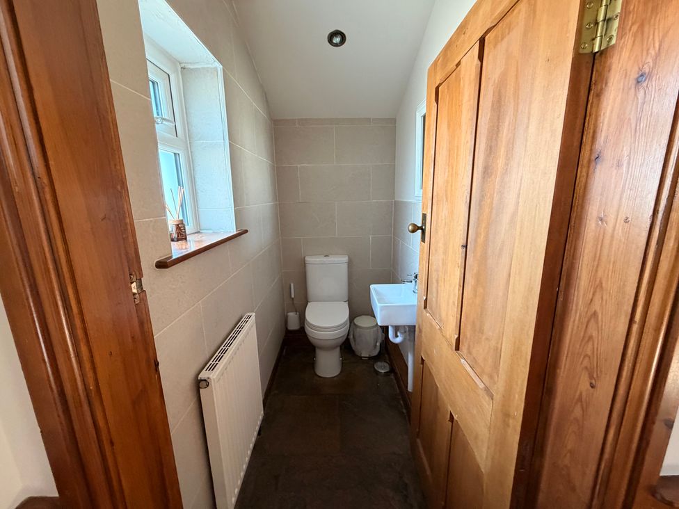 A bathroom with a toilet and sink at The Farmhouse in Boggle Hole near Robin Hood's Bay