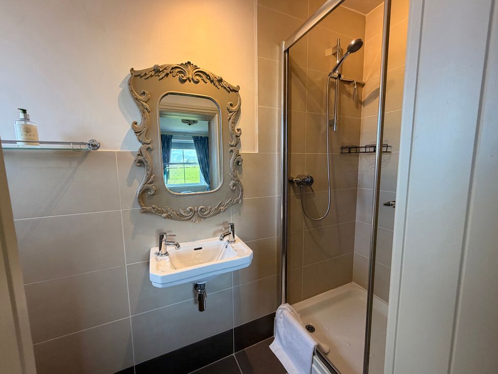 A bathroom with a sink and shower at The Farmhouse in Boggle Hole near Robin Hood's Bay
