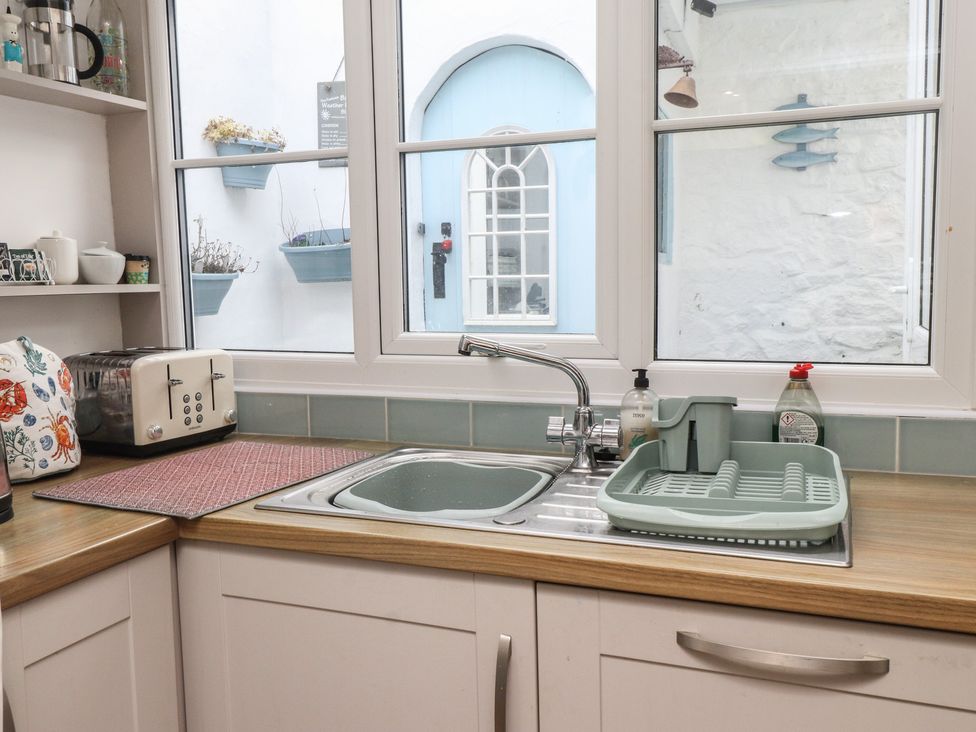 A kitchen with a sink and toaster at Dolfor in Nefyn
