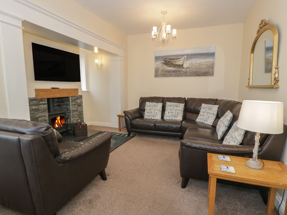 A living room with a sofa and armchairs at Roma in Rhos-on-Sea