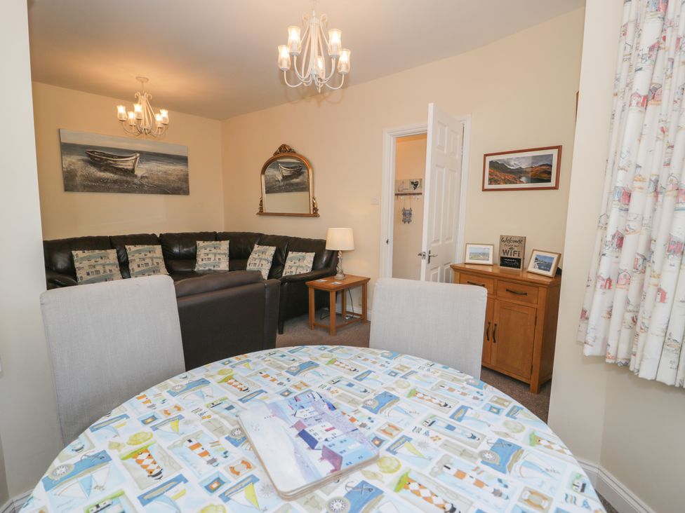 A living room with a sofa and table at Roma in Rhos-on-Sea