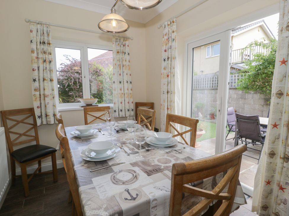 A dining room with a table set for meals at Roma in Rhos-on-Sea