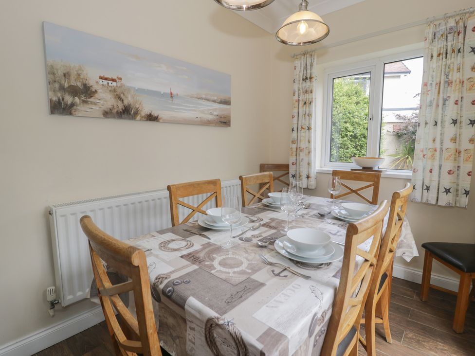 A dining room with a table and chairs at Roma in Rhos-on-Sea