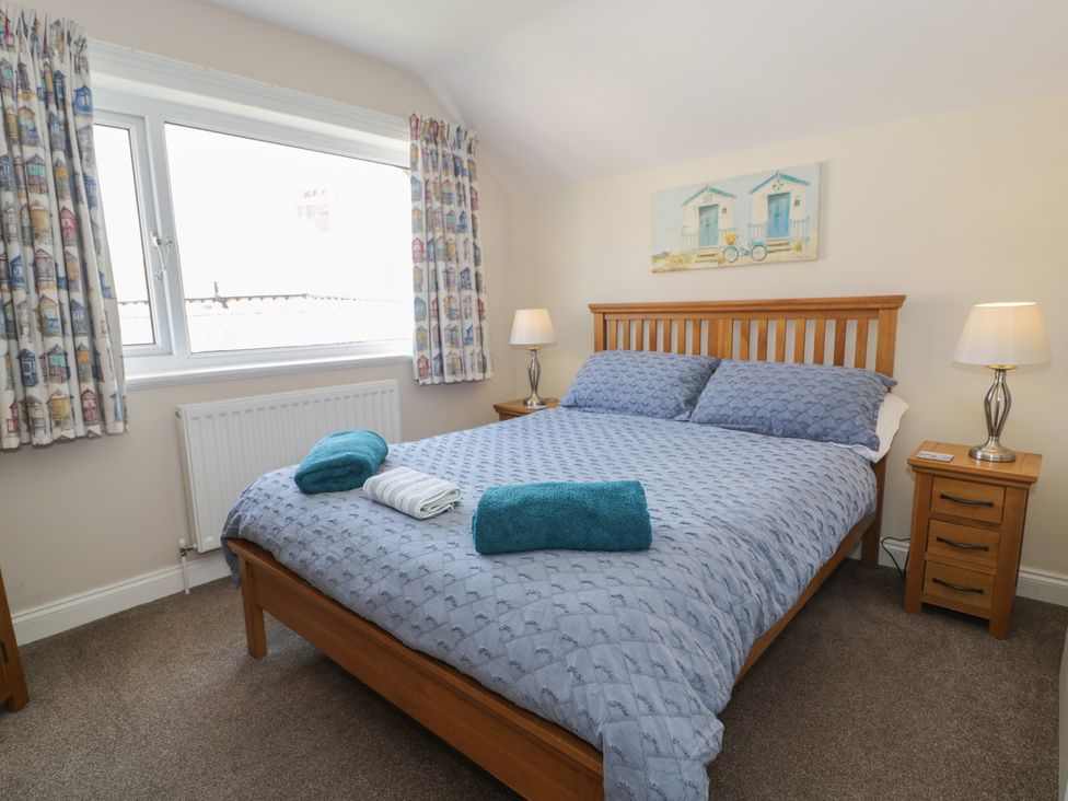 A bedroom with a bed and bedside tables at Roma in Rhos-on-Sea