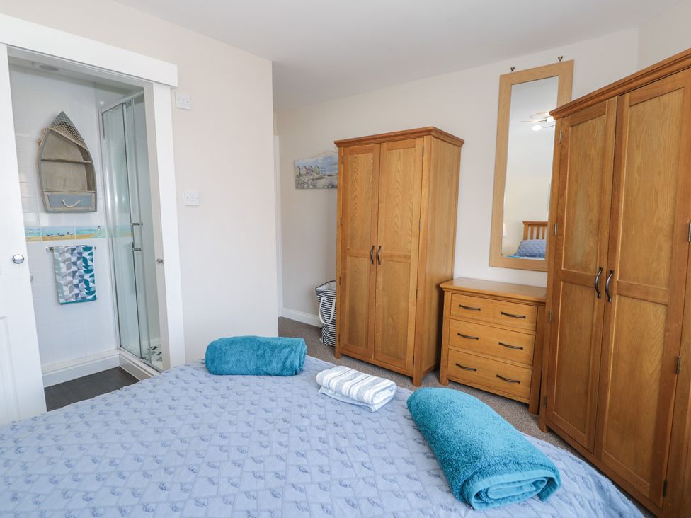 A bedroom with wardrobes and a shower at Roma in Rhos-on-Sea