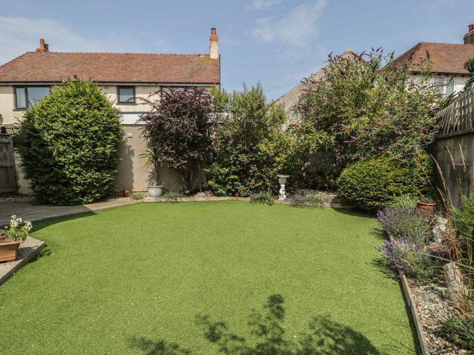 A garden with artificial grass and planters at Roma in Rhos-on-Sea
