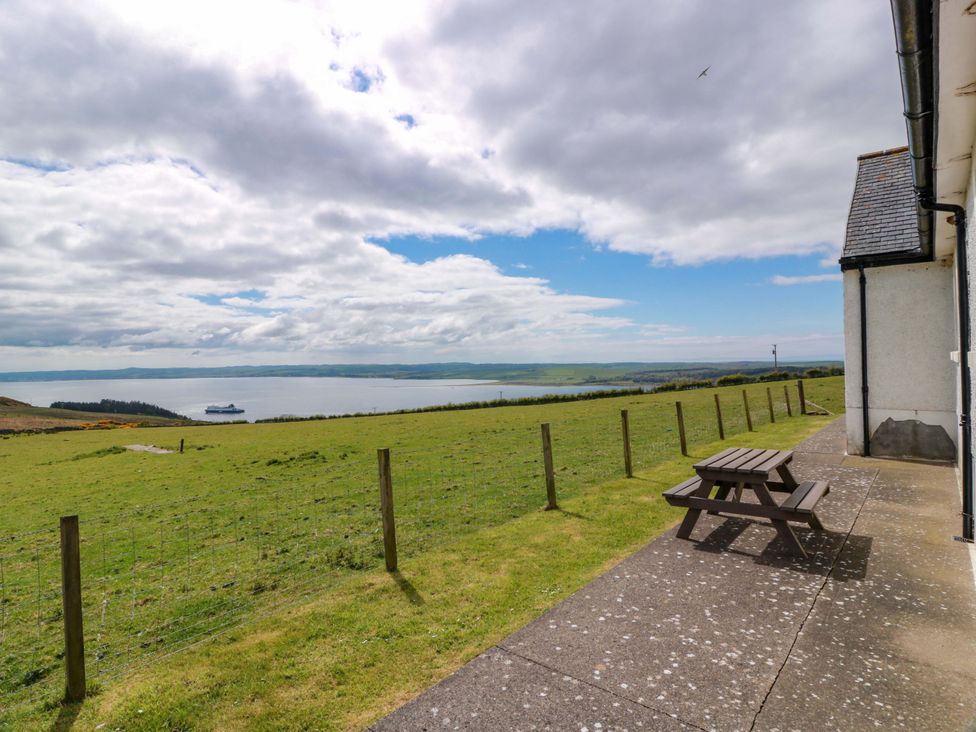 A picnic table with benches overlooking water at Little Laight Cairnryan near Stranraer