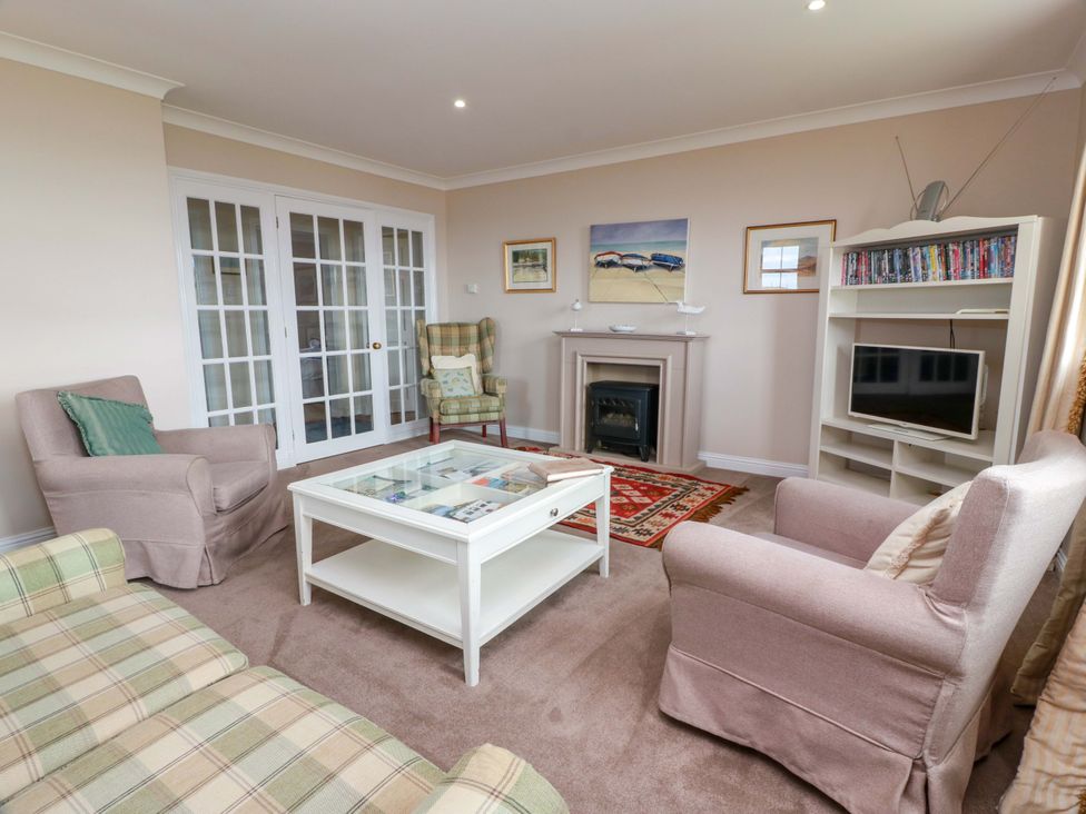 A living room with a coffee table and television at Little Laight in Cairnryan near Stranraer