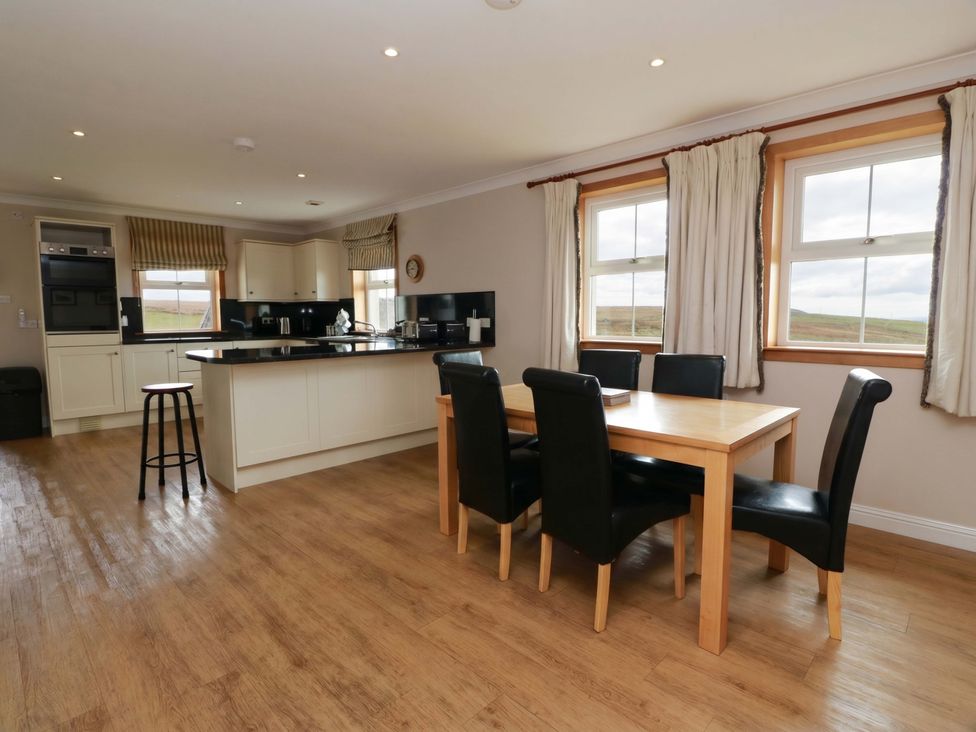 A kitchen with a dining table and chairs at Little Laight in Cairnryan near Stranraer