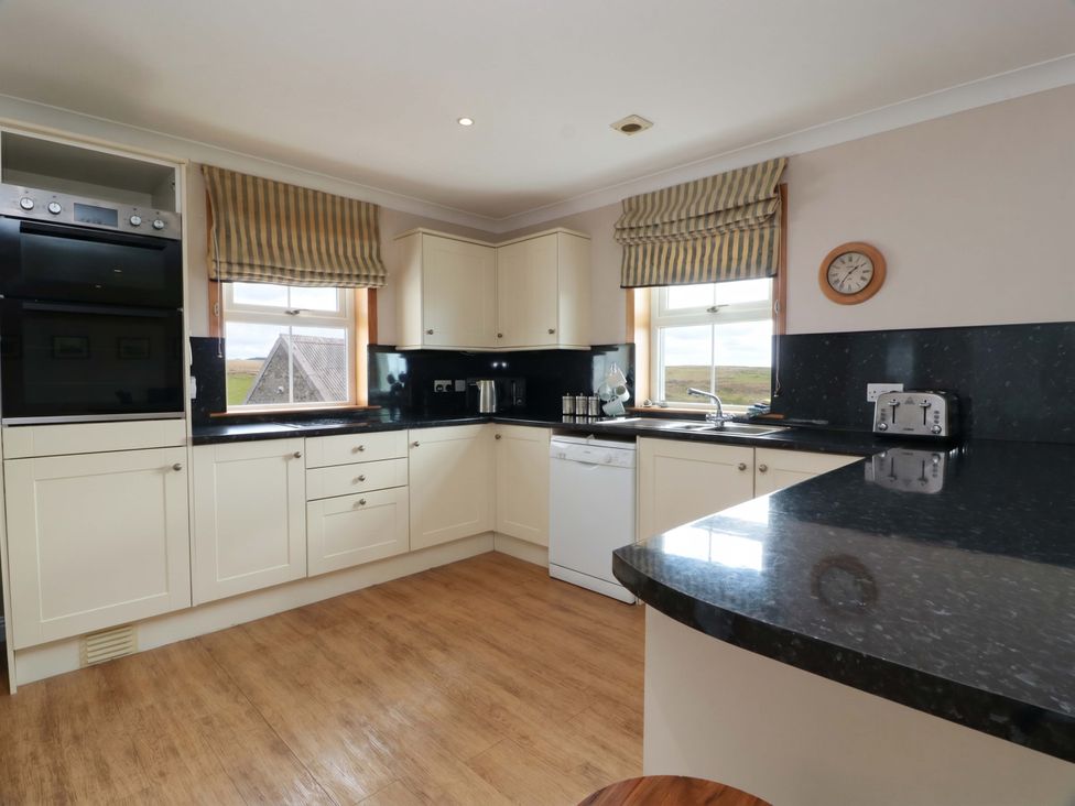 A kitchen with cabinets and a sink at Little Laight Cairnryan near Stranraer
