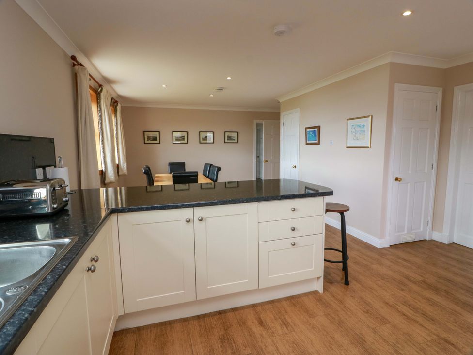 A kitchen with island and dining area at Little Laight Cairnryan near Stranraer
