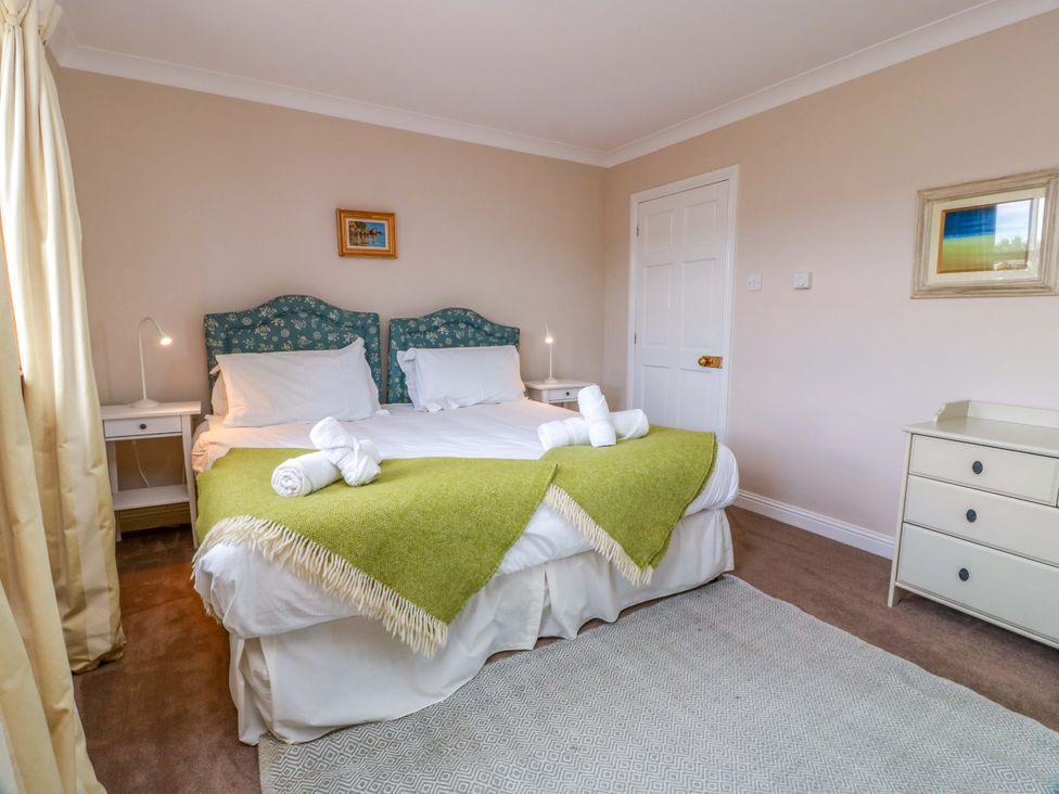 A bedroom with a bed and nightstand at Little Laight in Cairnryan near Stranraer