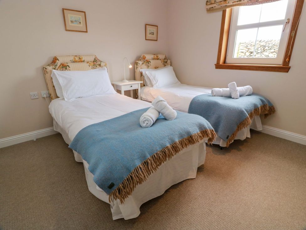 A bedroom with two single beds and a bedside table at Little Laight Cairnryan near Stranraer