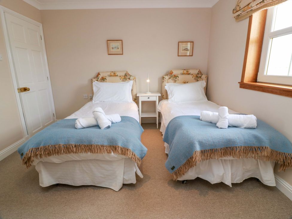 A bedroom with two single beds and a bedside table at Little Laight in Cairnryan near Stranraer