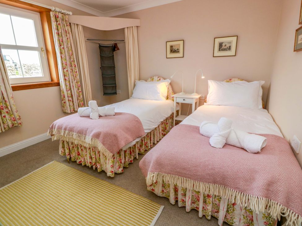 A bedroom with two beds and a bedside table at Little Laight Cairnryan near Stranraer