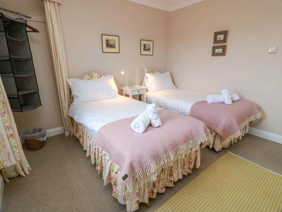 A bedroom with two beds and a table at Little Laight Cairnryan near Stranraer
