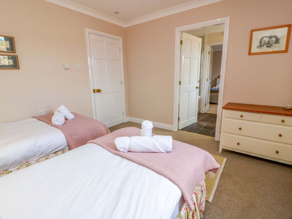 A bedroom with twin beds and a dresser at Little Laight Cairnryan near Stranraer