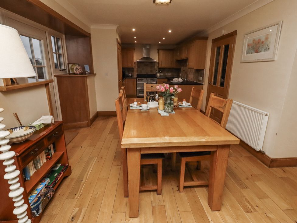 A dining room with a table and chairs at Long Cart Cottage in Embleton