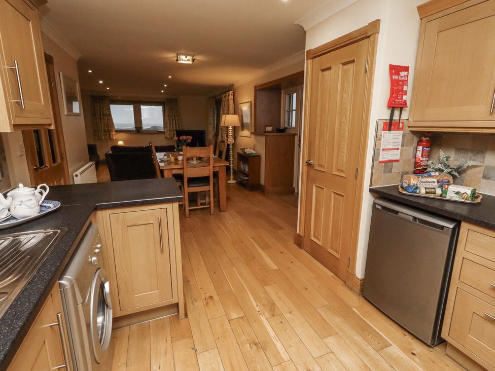A kitchen with a dining area and a sofa at Long Cart Cottage in Embleton