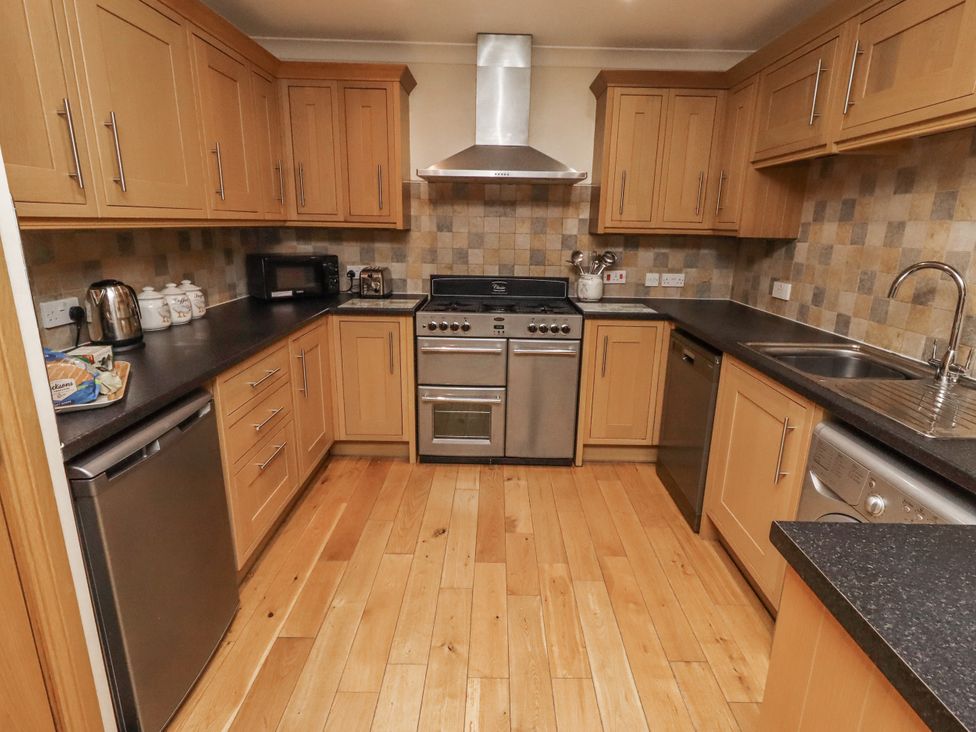 A kitchen with cabinets and appliances at Long Cart Cottage in Embleton