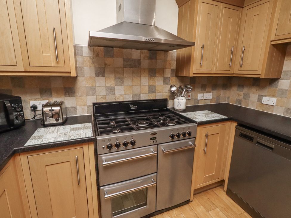 A kitchen with an oven and appliances at Long Cart Cottage in Embleton