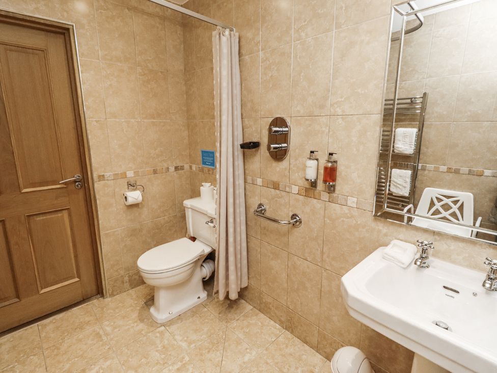 A bathroom with a toilet and sink at Long Cart Cottage in Embleton