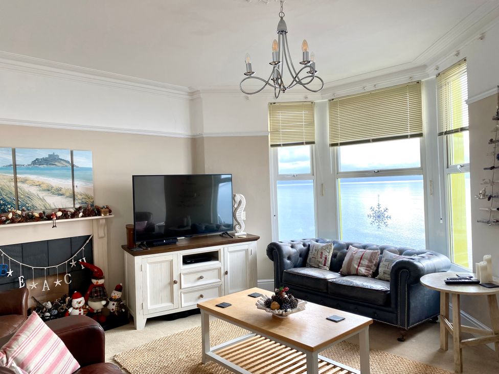 A living room with a sofa and television at The View in Criccieth