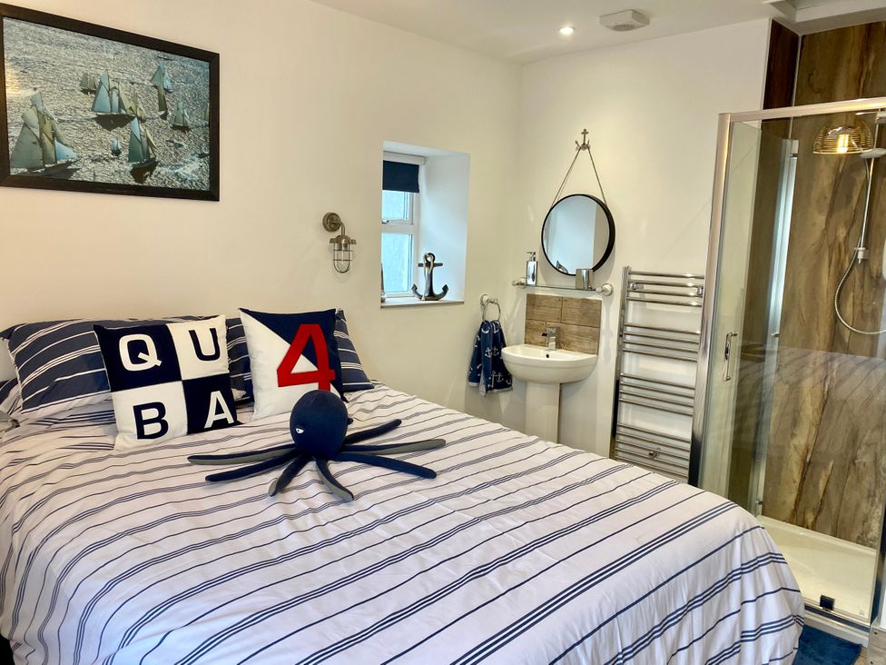 A bedroom with a bed and en-suite bathroom at The View in Criccieth