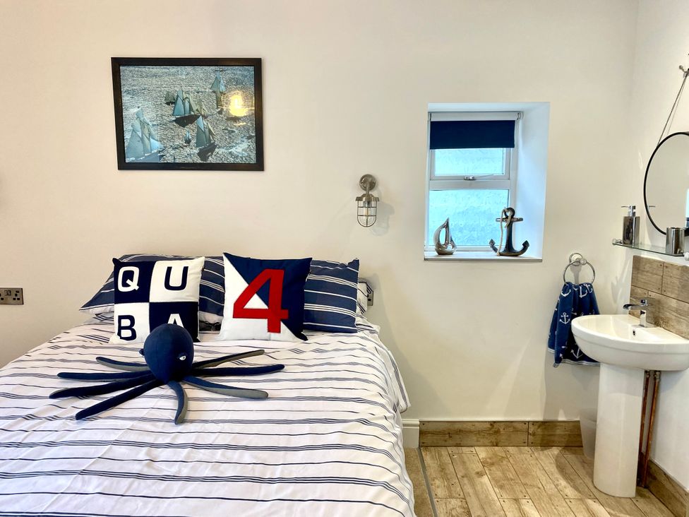 A bedroom with a bed and decor items at The View in Criccieth