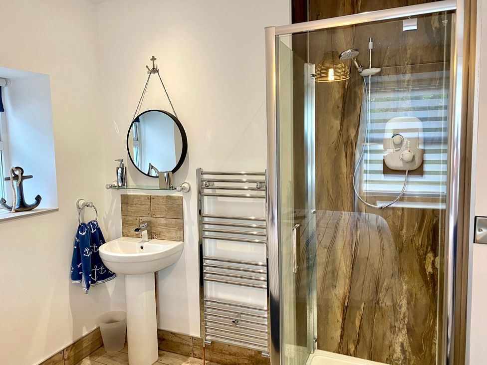 A bathroom with a shower and sink at The View in Criccieth