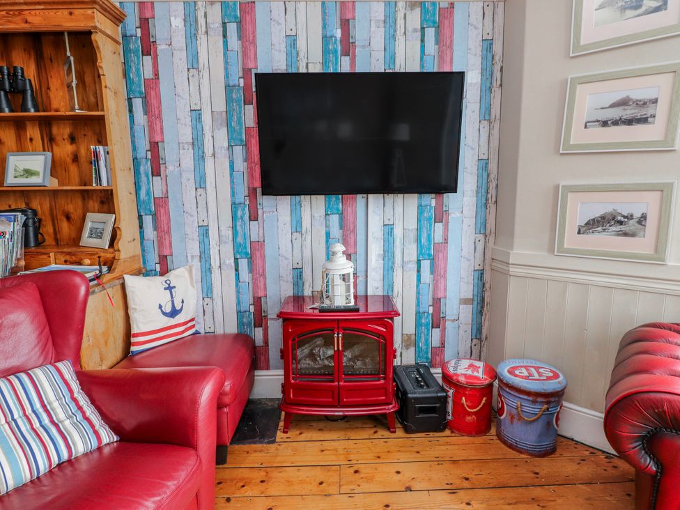 A living room with a television mounted on the wall at The View in Criccieth