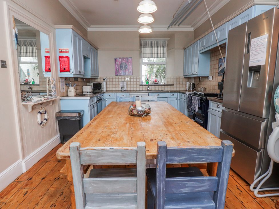 A kitchen with a table and chairs at The View in Criccieth