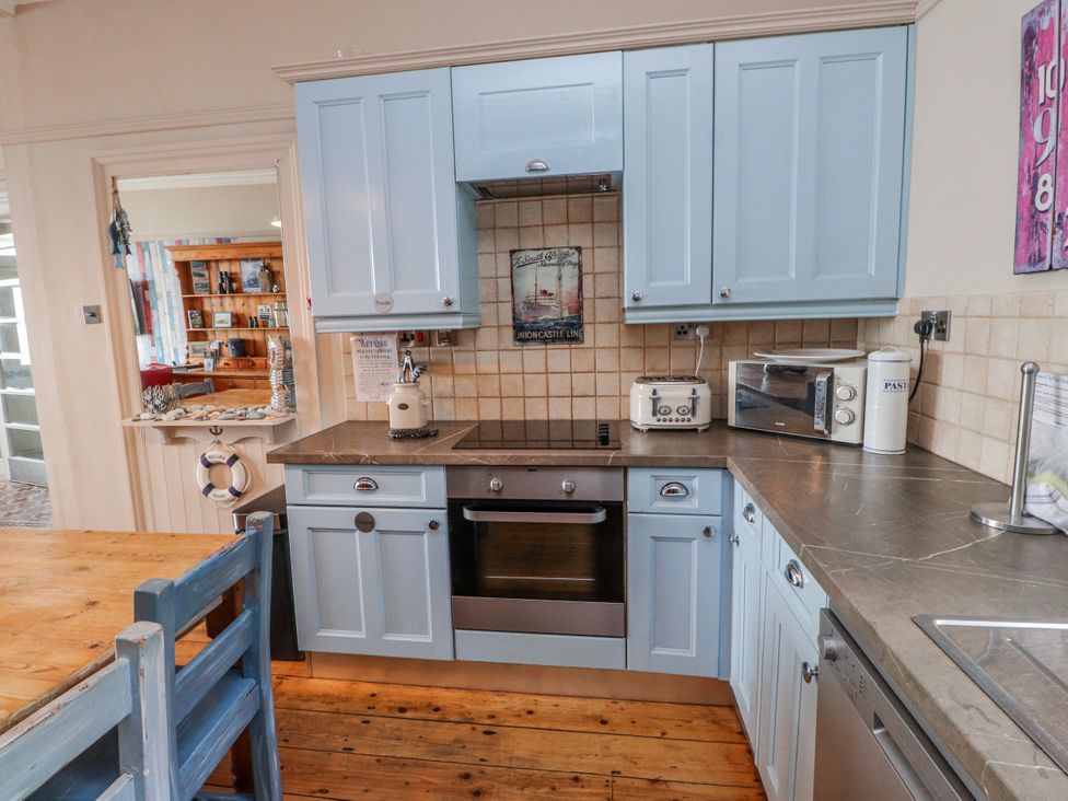 A kitchen with cabinets, oven, and appliances at The View in Criccieth