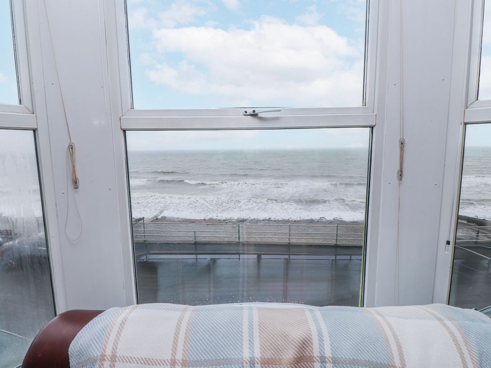 A view of the ocean from a window in a living room at The View in Criccieth