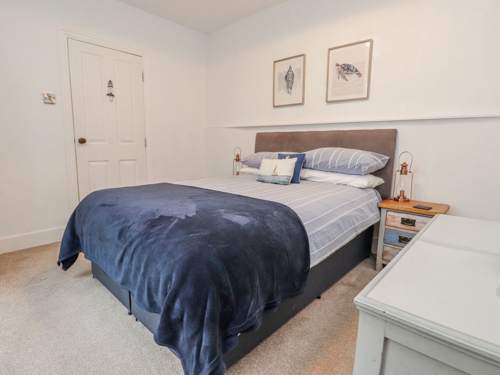 A bedroom with a bed and side table at The View in Criccieth