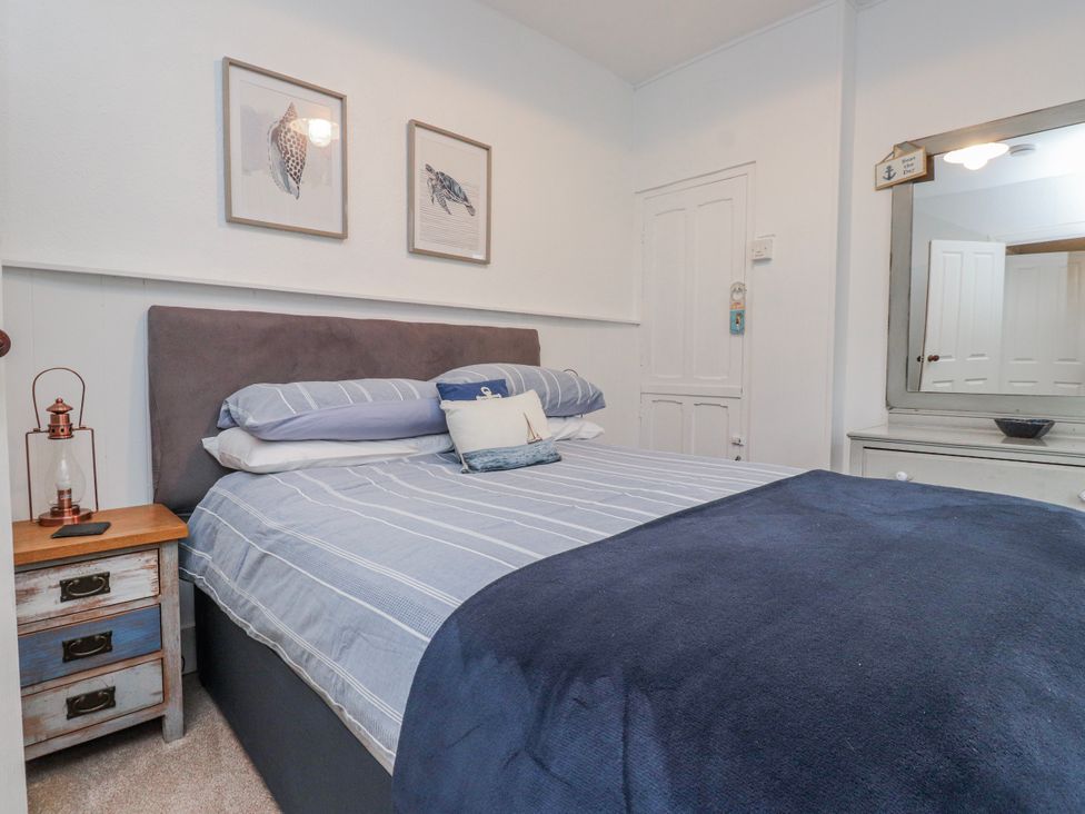 A bedroom with a bed and bedside table at The View in Criccieth