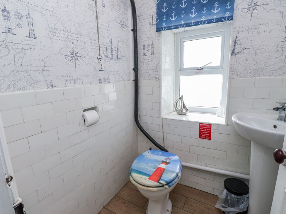 A bathroom with a toilet and sink at The View in Criccieth