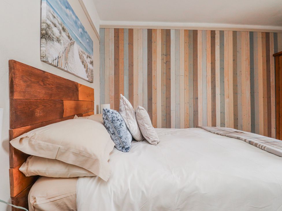 A bedroom with a bed and pillows at The View in Criccieth