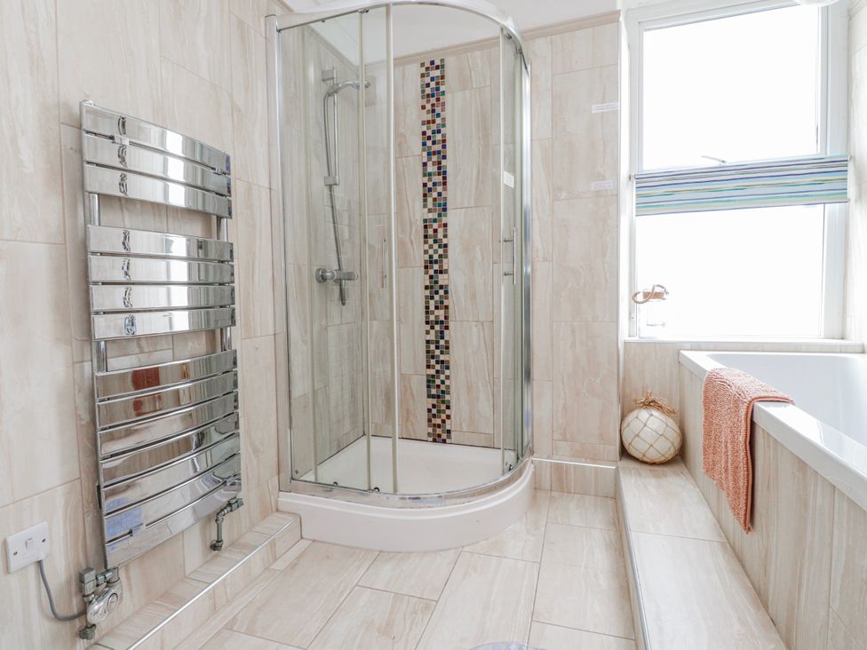 A bathroom with a shower and bathtub at The View in Criccieth