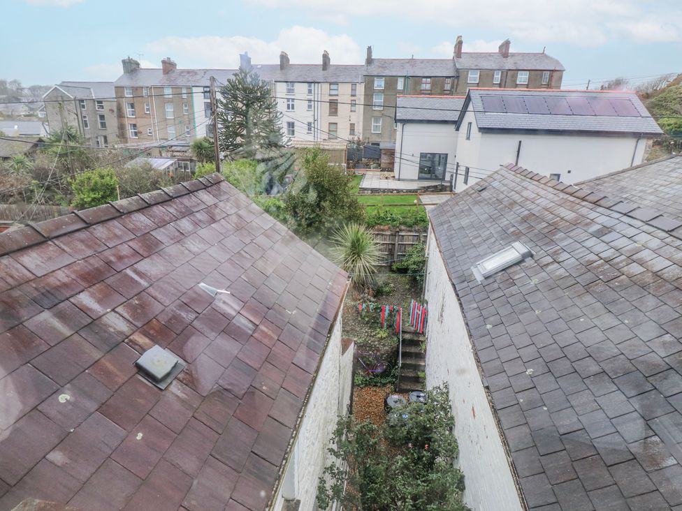 A view showing rooftops, plants, and a courtyard at The View in Criccieth