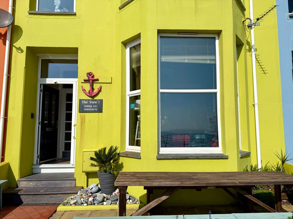 An entrance with a sign and table at The View in Criccieth