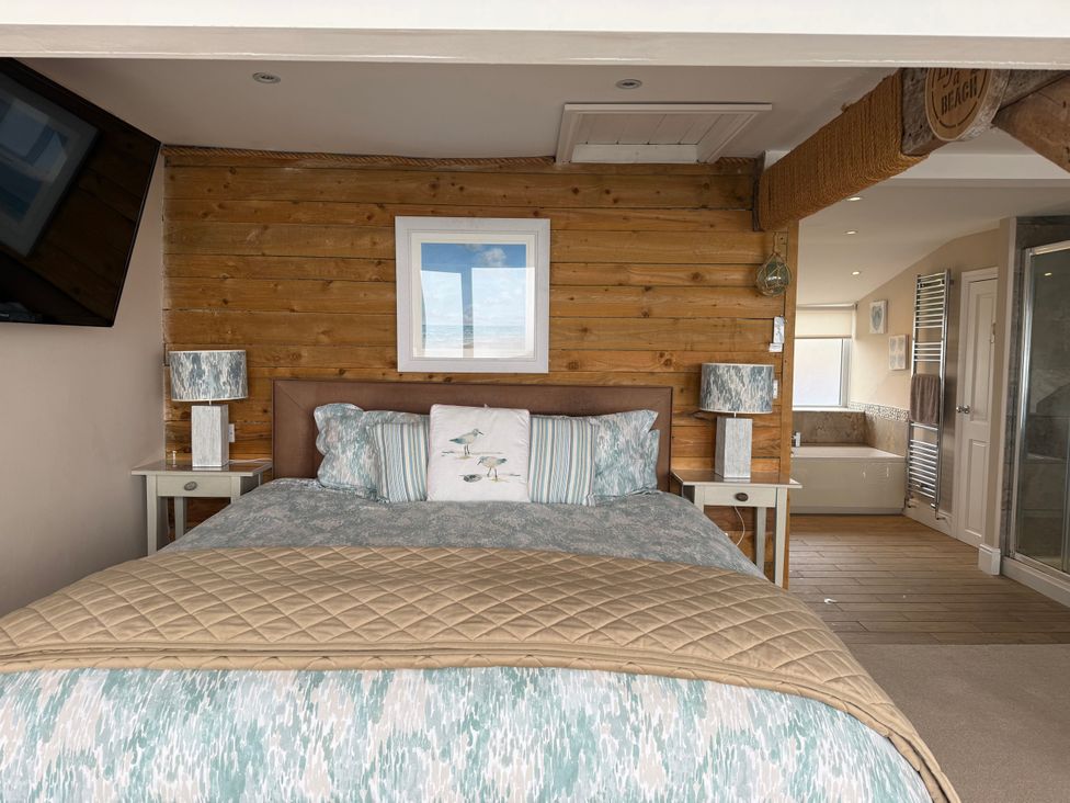 A bedroom with a bed and bedside tables at The View in Criccieth